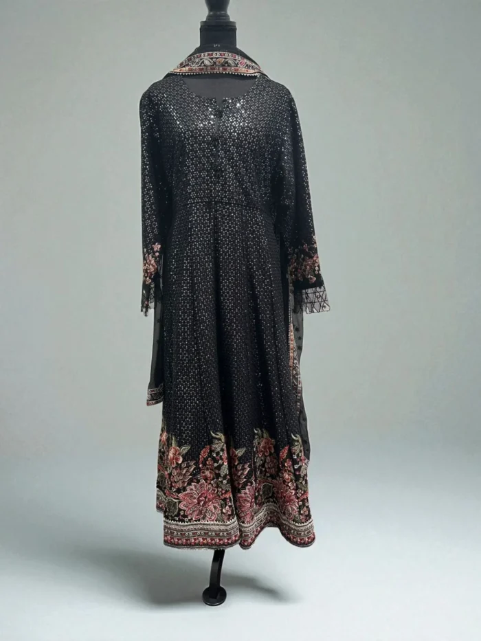 Black sequined maxi dress with a colorful floral embroidered border on the hem.