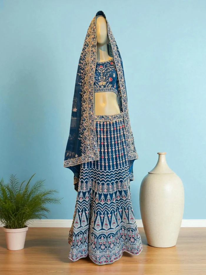 Teal blue net lehenga choli with shimmery embroidery.