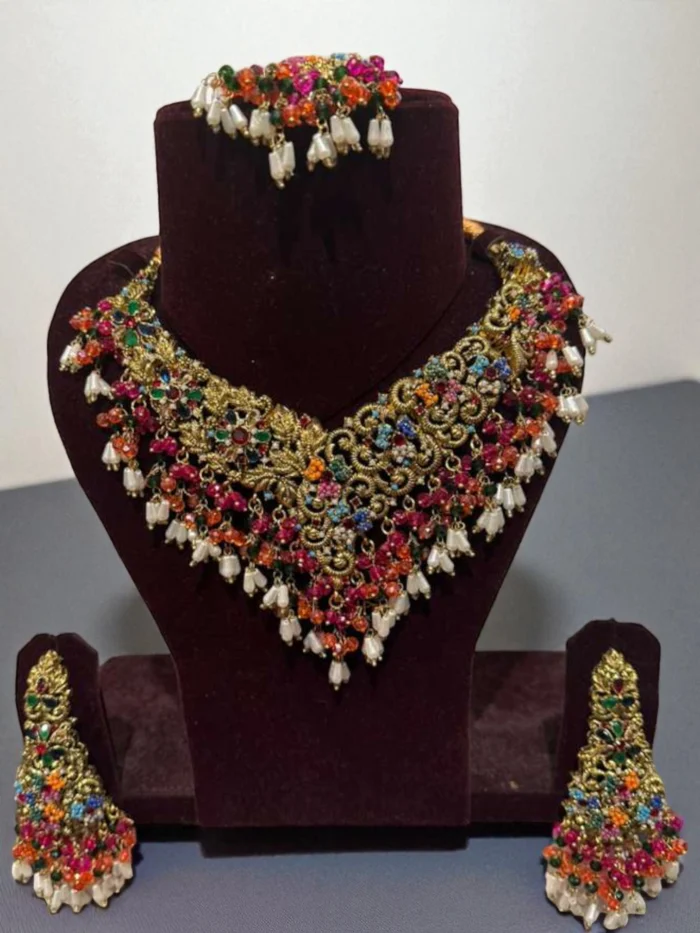 Antique gold choker set with multi-color stones, clear crystals, and white pearl tassel drops.