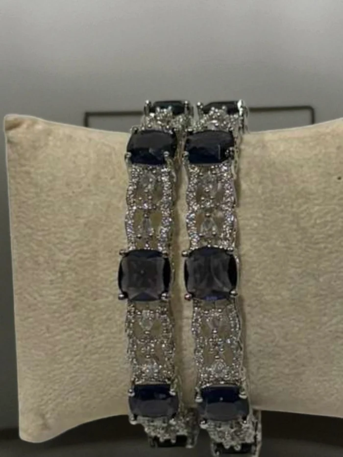 Silver plated bangles with alternating dark purple stones and clear crystal lattice work.