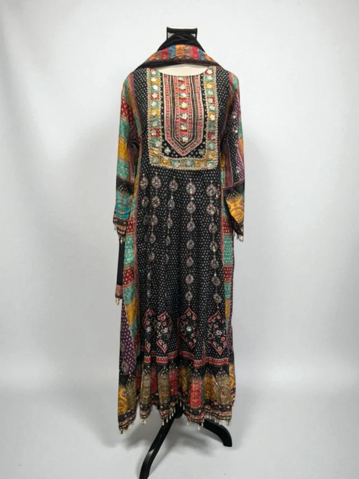 Black maxi dress with vibrant multi-color print, heavy hand embroidery, and pasted mirror work on the yoke.