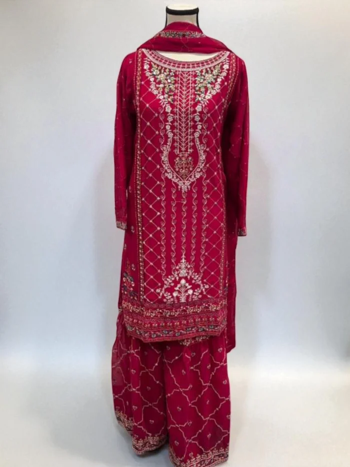 Hot pink chiffon gharara suit with intricate white thread embroidery and floral accents on the shirt and the gharara pant.