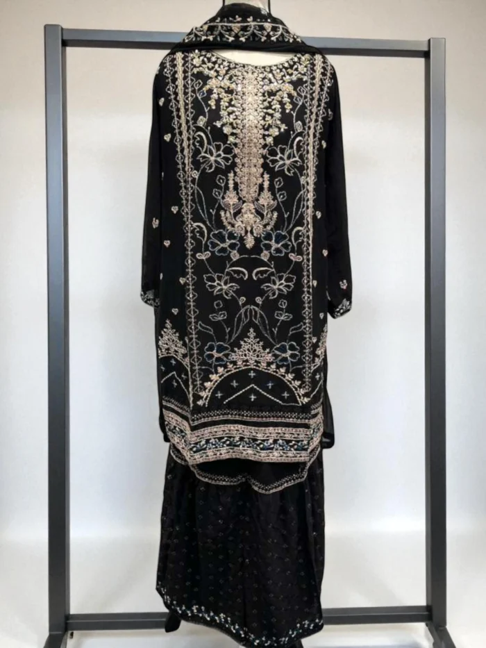 Black chiffon gharara suit with intricate white and blue floral thread embroidery on the kurta and the voluminous gharara pant.