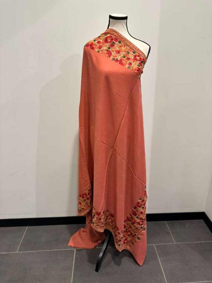 Long coral pashmina shawl with heavy, multi-color floral embroidery along the borders.