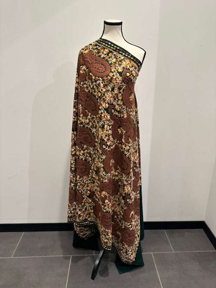Long Kashmiri pashmina shawl with an all-over traditional paisley and floral pattern in brown, mustard, and white on a dark green base.