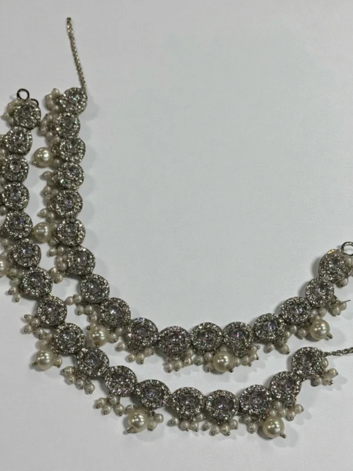 Pair of silver polish anklets with intricate linked leaf-shaped AD stone settings and heavy clusters of dangling faux pearls.