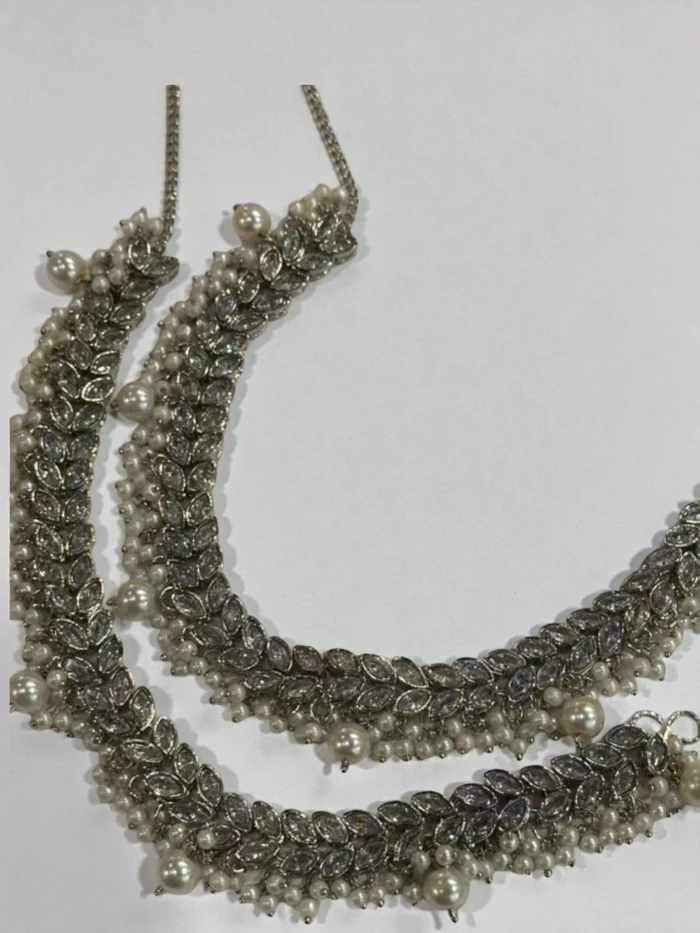 Pair of silver polish anklets with intricate linked leaf-shaped AD stone settings and heavy clusters of dangling faux pearls.