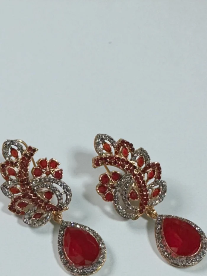 Zircon drop earrings with an intricate feather motif and a large teardrop stone,
