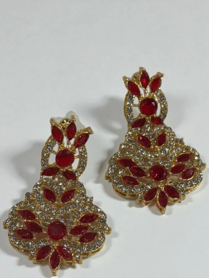 Zircon statement drop earrings in an ornate floral pattern, shown in gold plated red.