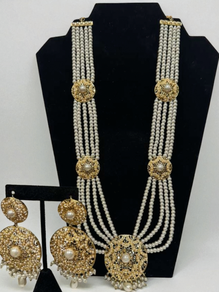 Gold plated traditional Hyderabadi Rani Haar long necklace with multiple strands of white pearls and ornate floral filigree accents, with matching round earrings.