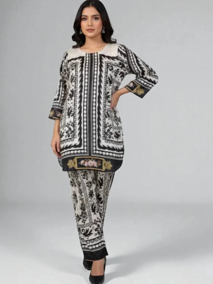 Female model wearing a black and white printed silk Kurta set with strong vertical and horizontal geometric borders and an all-over patterned trouser.