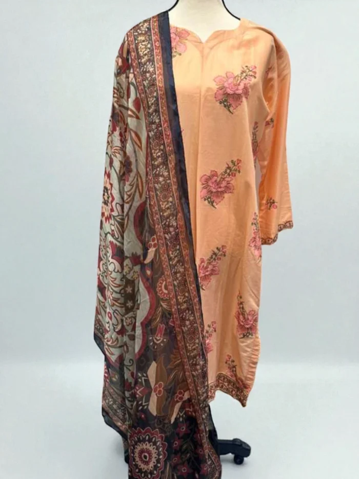 Mannequin wearing a peach cotton Kurta with subtle pink floral embroidery, matching trousers, and a dark navy and brown Doria printed dupatta.